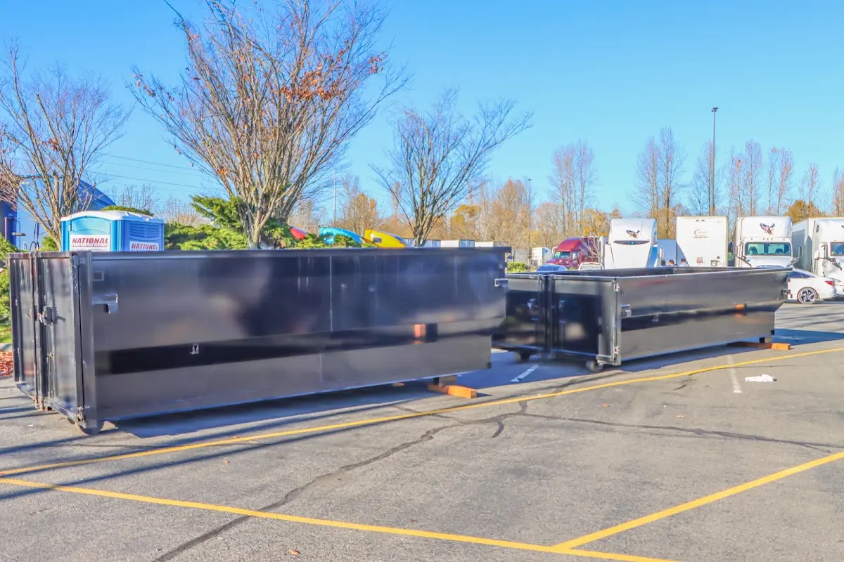 Professional dumpster rental service with roll-off container on residential driveway in Sioux Center